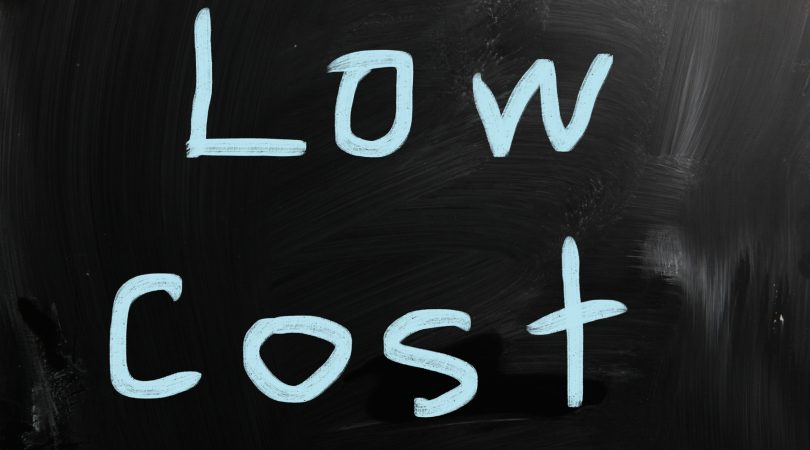 “Low cost” handwritten with white chalk on a blackboard